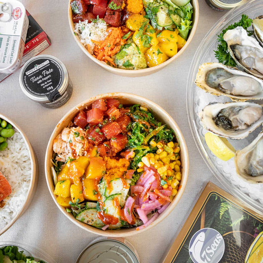 Variety of seafood set on a table. Including poke bowls oyster platter and caviar.