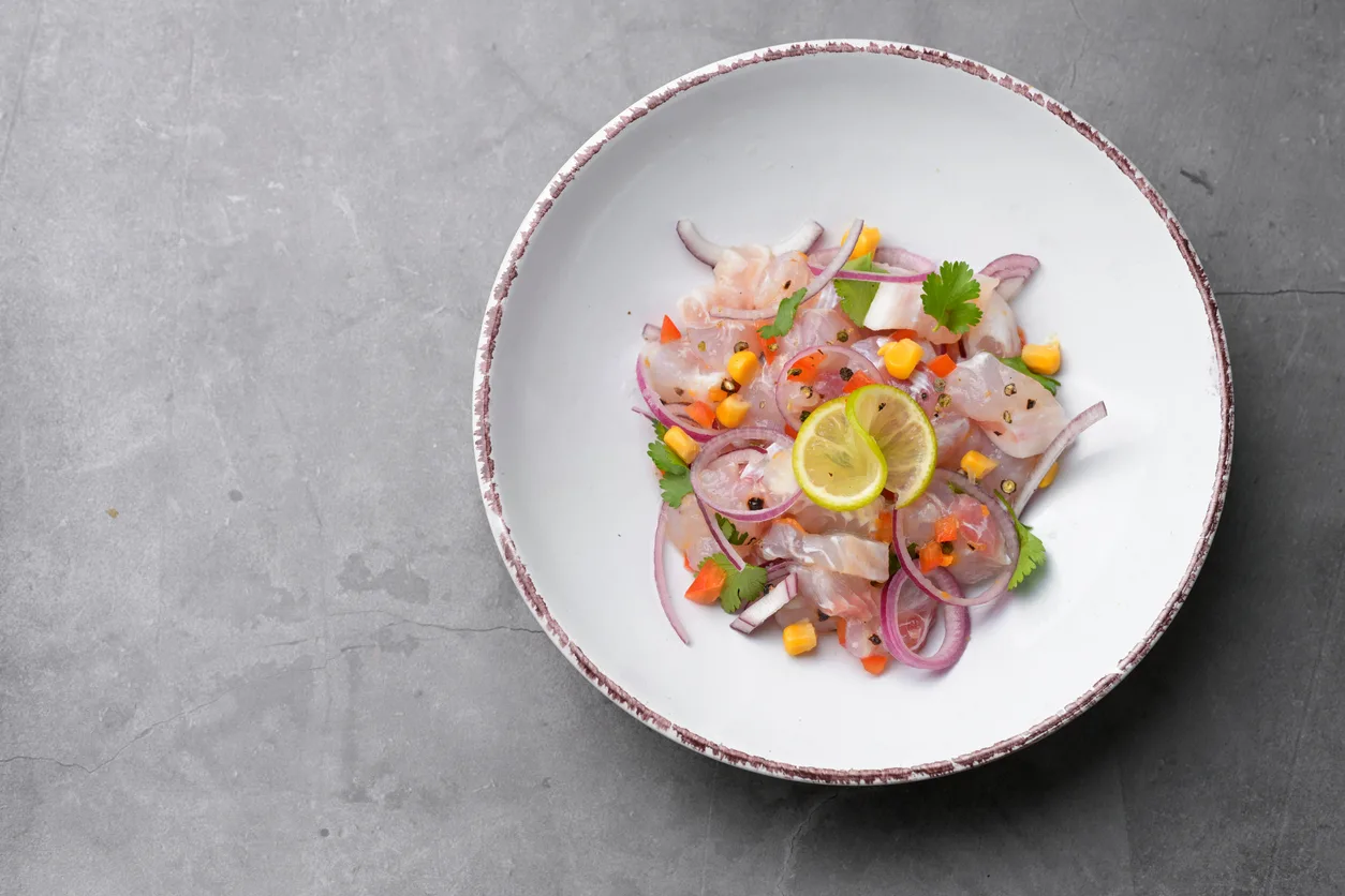 Fresh ceviche decorated with lime, corn
